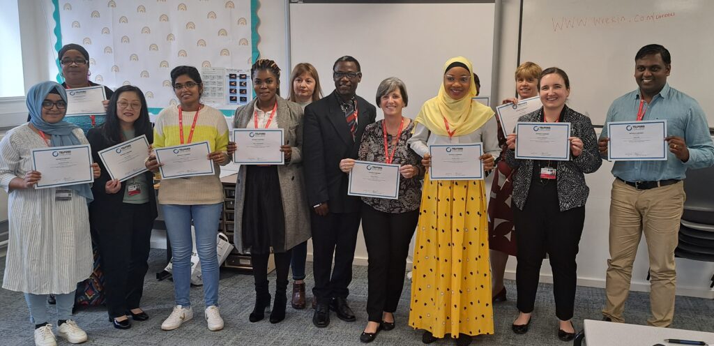 A group of students showing their certificates for passing their course